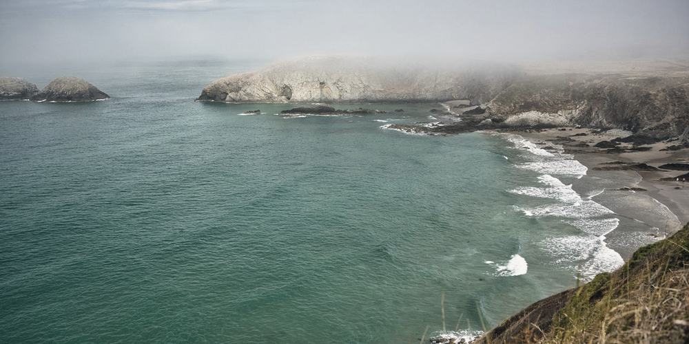A misted coastline seen from high ground