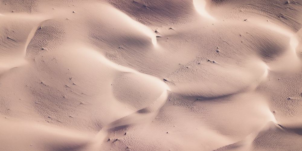 Rippled sand in raking light, receding into the distance