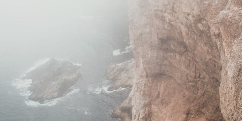 A headland half lost in sea fog